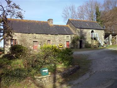Modern house, ancient stone buildings in private setting.