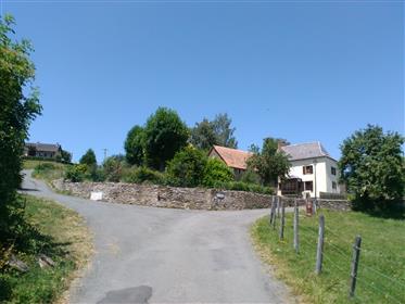 Stone farmhouse and barn in foothills of aubrac mountains